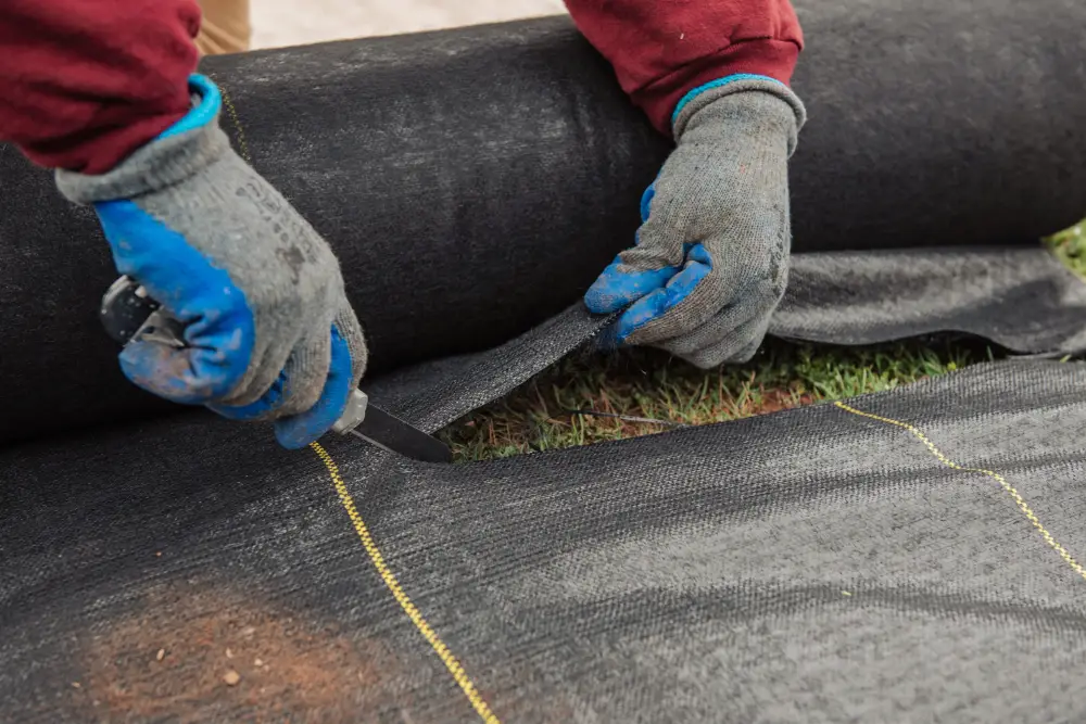 Closeup of Willis Commercial Landscaping tech's hands installing lining Closeup of Willis Commercial Landscaping tech's hands installing lining
